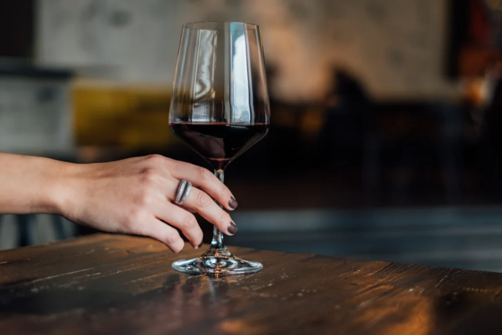 Wmoan hand holding a glass of wine